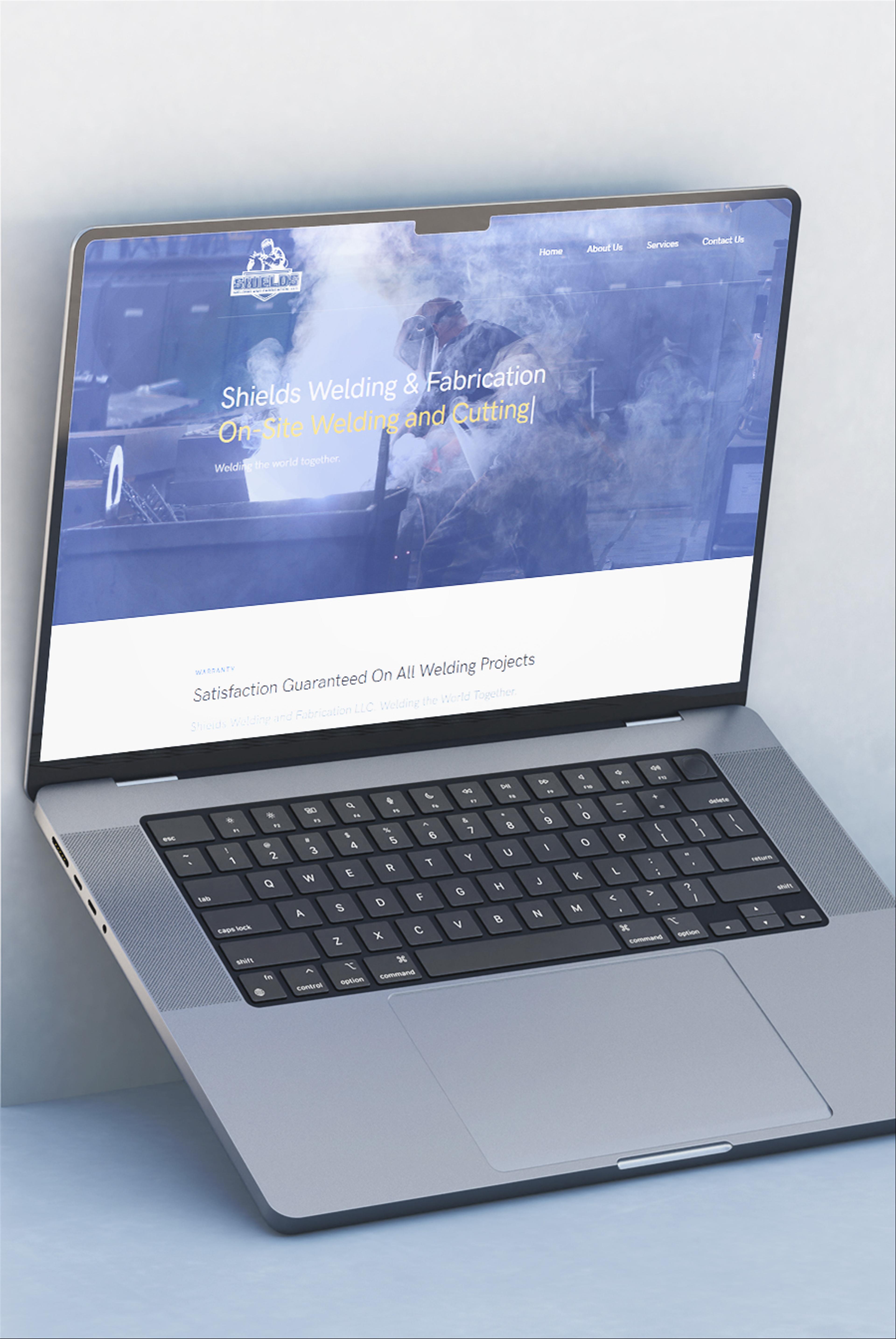 Shields Welding website shown on an apple laptop